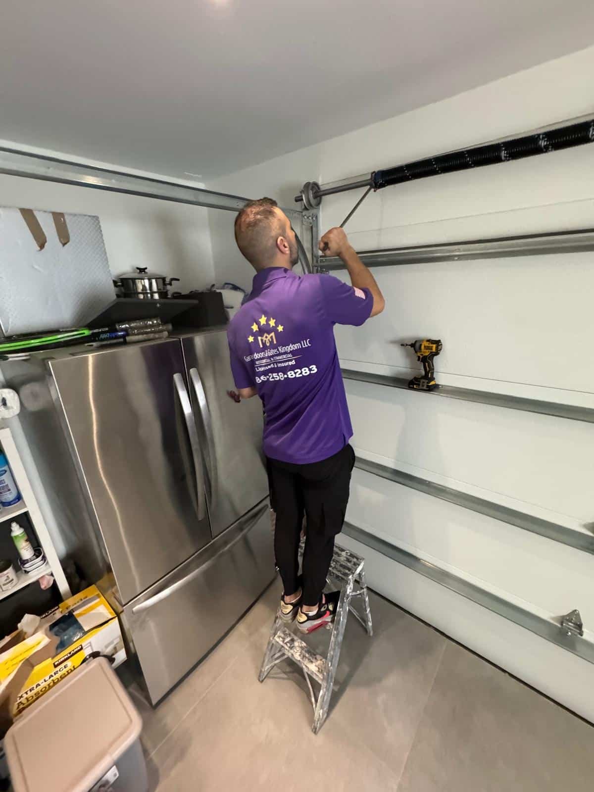 Garage Door Kingdom technician replacing garage door spring in Sunrise, FL — same-day torsion spring replacement service