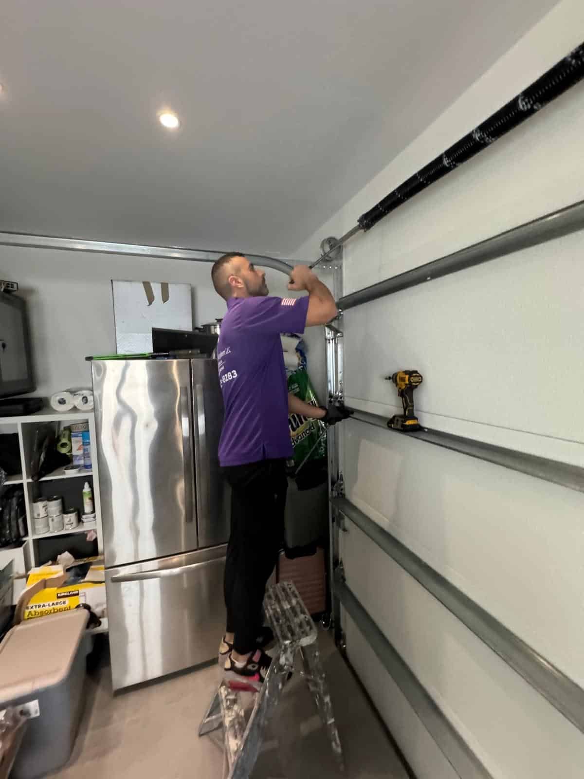 Garage Door Kingdom technician repairing a garage door in Sunrise, FL — same-day residential garage door repair service