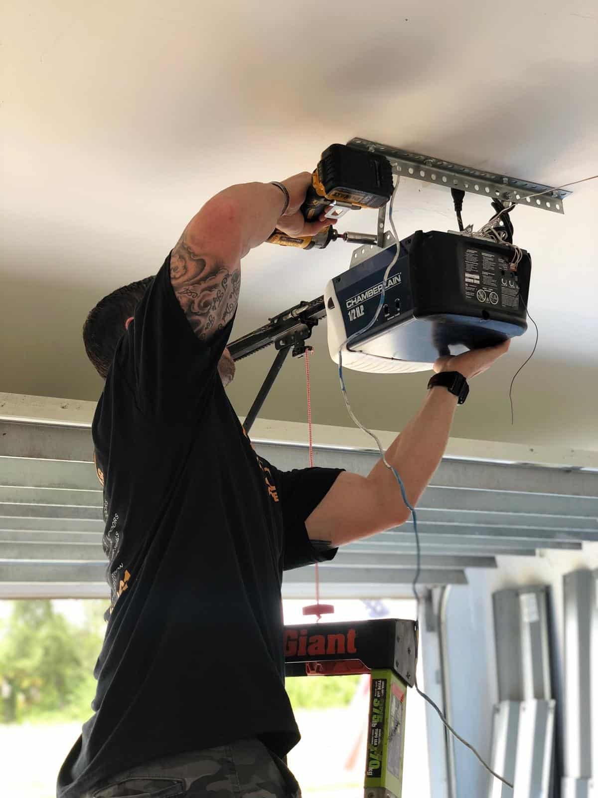Garage Door Kingdom technician installing a garage door opener in Sunrise, FL — professional smart opener installation service Broward County