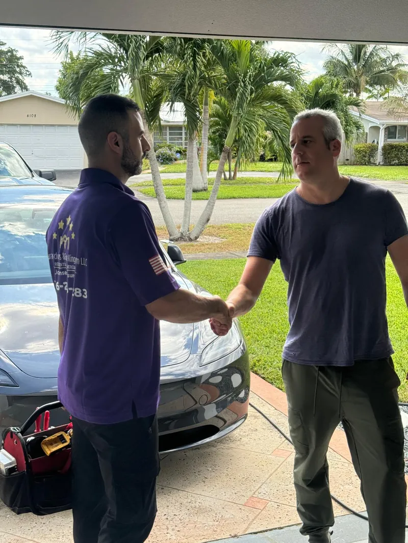 Garage Door Kingdom technician shaking hands with a satisfied homeowner after completing a garage door install in Broward County, FL