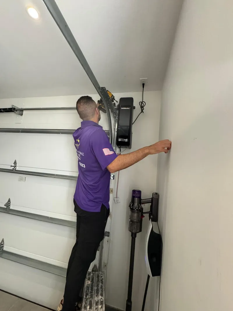 Garage Door Kingdom technician installing a LiftMaster myQ Wi-Fi smart garage door opener in a Sunrise, FL home