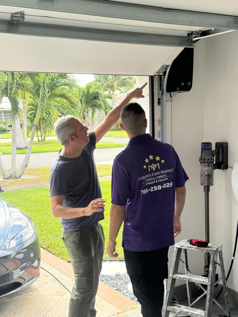 Yarin Ifergan, owner of Garage Door Kingdom, on-site consulting a homeowner about a garage door opener issue in Sunrise, FL